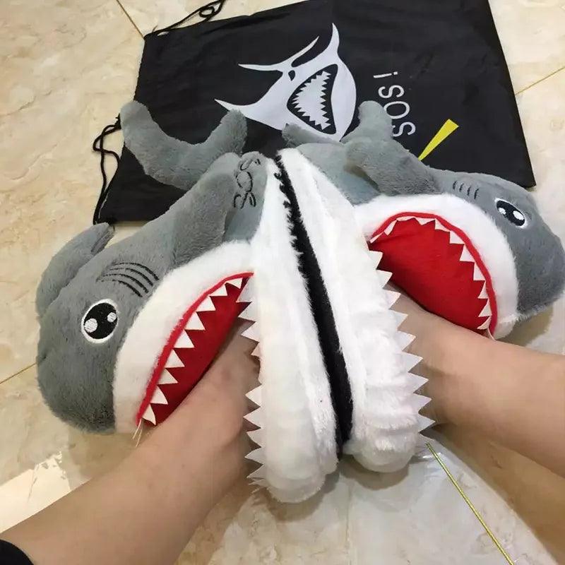 A person enjoying cozy comfort while wearing a pair of Silly Sausage shark-themed animal slippers.