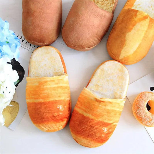 A group of Silly Sausage bread-shaped slippers and donuts on a table.