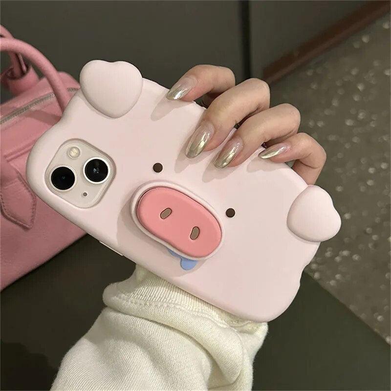 A pink piggy phone case being held by a female on a green background